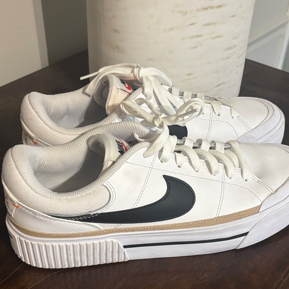 Nike Women's White Sneakers with Black Swoosh and Tan Accent